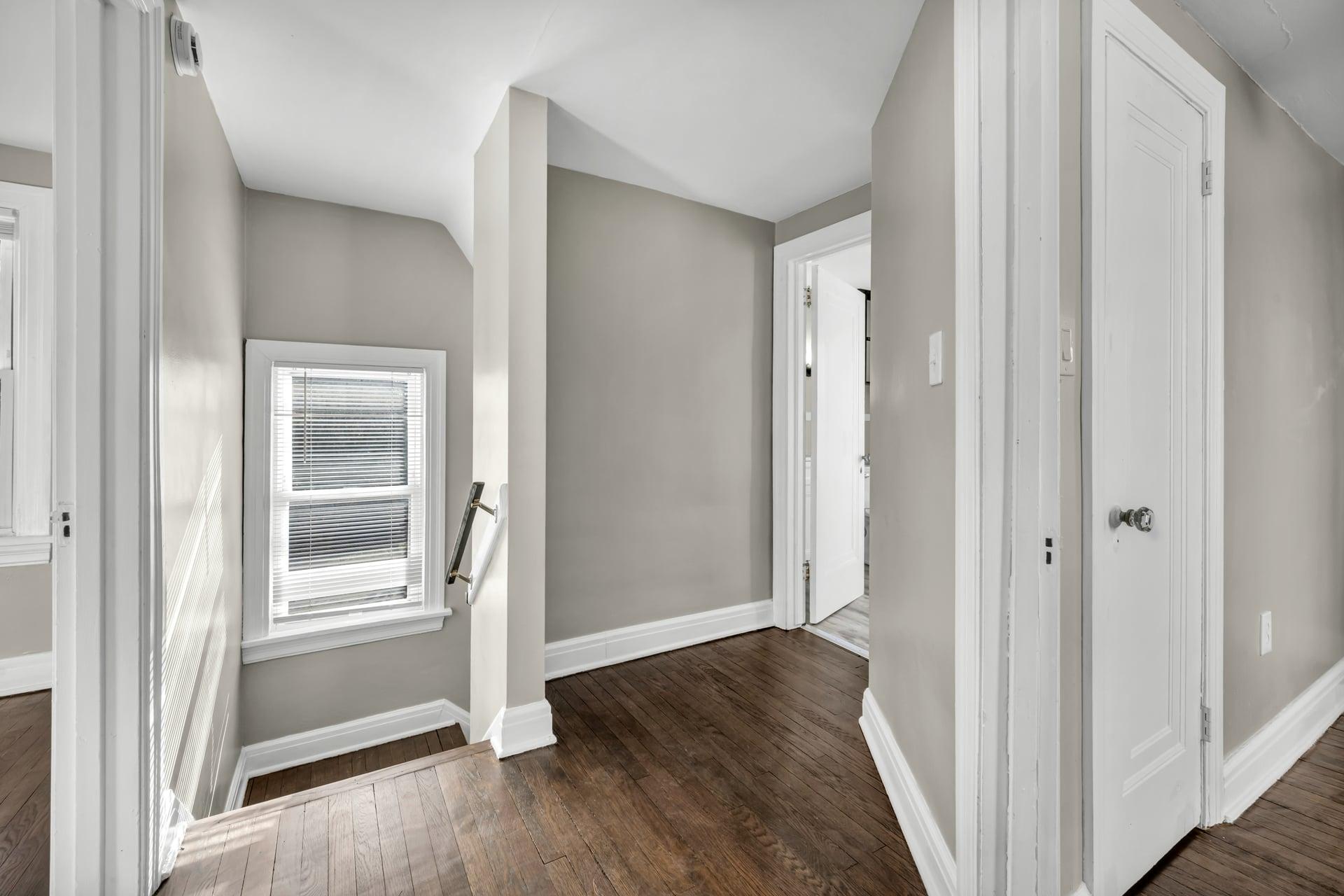 A clean, well-maintained residential hallway with hardwood flooring and neutral décor — the kind of shared space Memphis Property Services keeps clean, safe, and well-maintained for block management firms and residential operators.